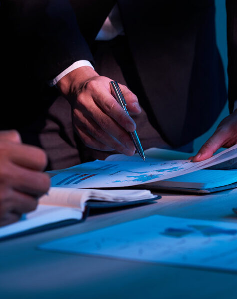 Close-up image of business partners working with financial documents