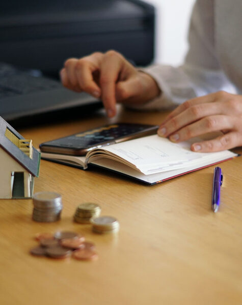 A closeup shot of a person thinking of buying or selling a house
